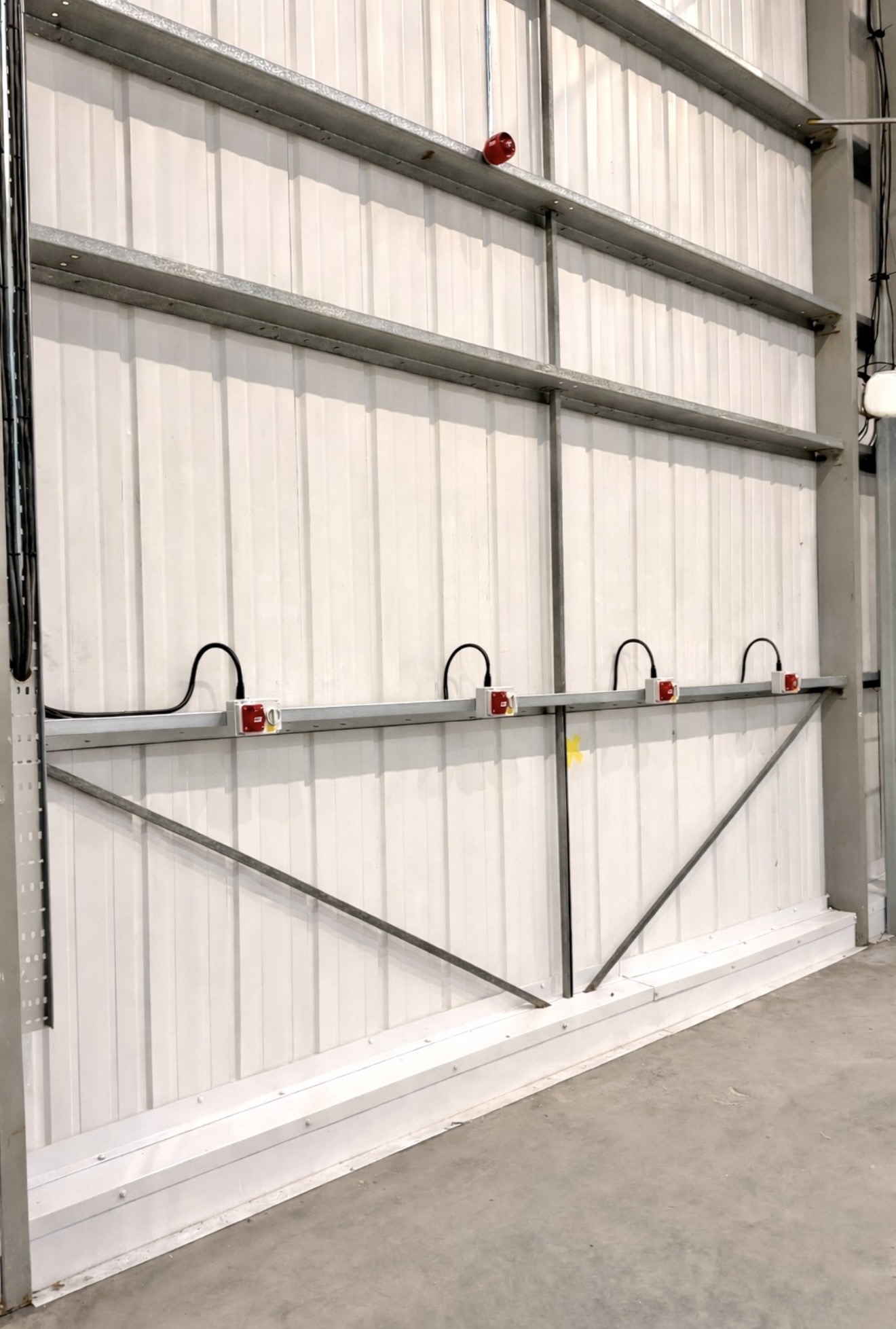 Industrial electrical installation on a warehouse wall
